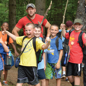 A group of scouts and a scouter smiling